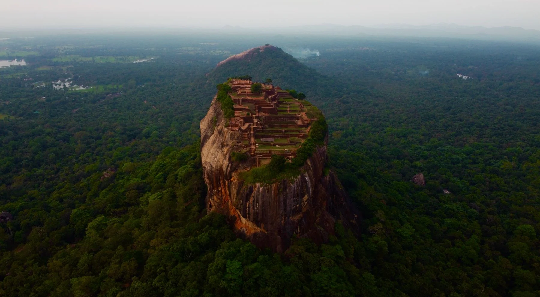 Sigiriya rock rising above the green forests of Sri Lanka